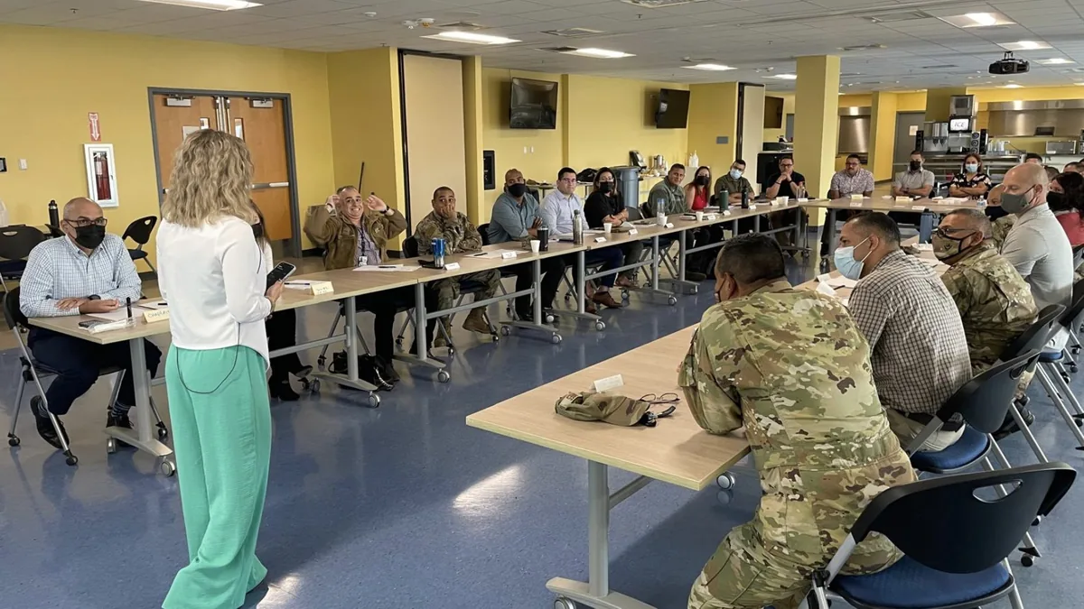 Krystalore Crews leading an interactive leadership training session in a classroom of service members